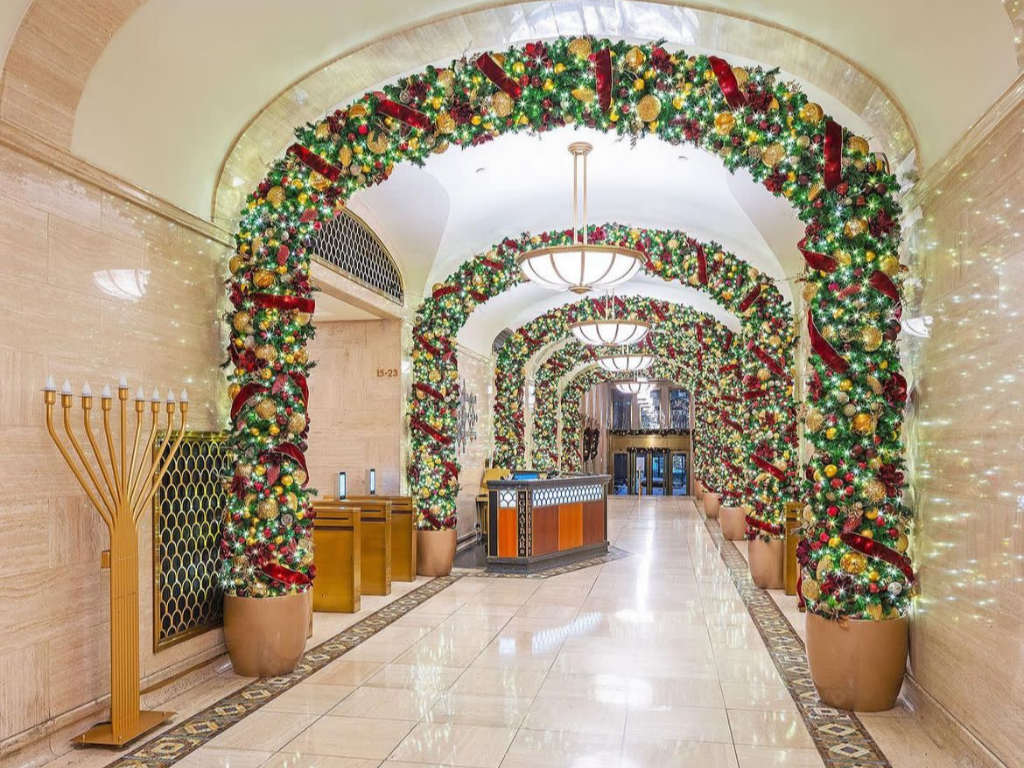 Gold and evergreen commercial holiday arch designed by Cambridge