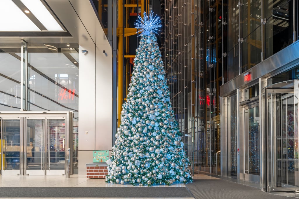 Floor-to-ceiling commercial Christmas tree in a New York lobby